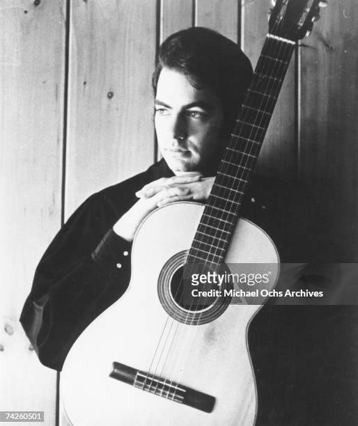 Singer Neil Diamond poses for a portrait with an acoustic guitar in circa 1968.