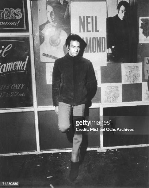 Singer Neil Diamond poses for a portrait in front of a marquee advertising a club where he is performing an engagement in circa 1967.