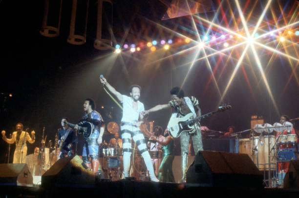 Members of American R&B and Pop group Earth Wind & Fire perform onstage, 1970s.