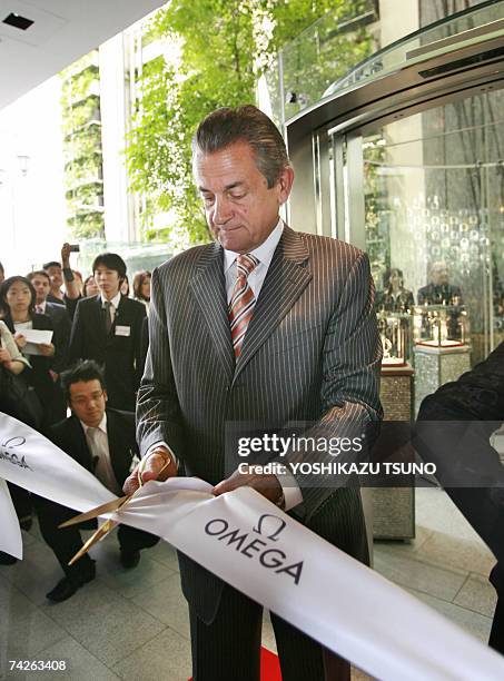 Swiss watch maker Omega president Stephen Urquhart cuts a ribbon as Swatch Group opens their new Tokyo showroom 24 May 2007, Omega is one of swtach...