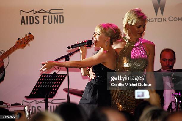 Kylie Minogue and Sharon Stone sing during the Amfar dinner against Aids,on May 23 2007 in Mougins France.