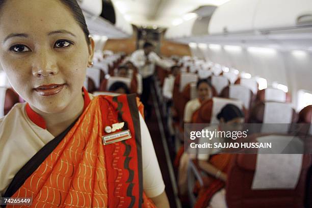 An Indian stewardess with Air India Express stands in the cabin of a newly acquired 737-800 Boeing aircraft in Mumbai, 24 May 2007. Air India...