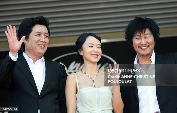 South Korean director Lee Chang-Dong and actors Do-Yeon Jeon and Kang-Ho Song wave to the crowd 24 May 2007 as they pose prior to attend the...