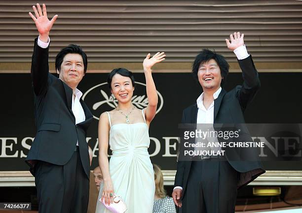 South Korean director Lee Chang-Dong and actors Do-Yeon Jeon and Kang-Ho Song wave to the crowd 24 May 2007 as they pose prior to attend the...