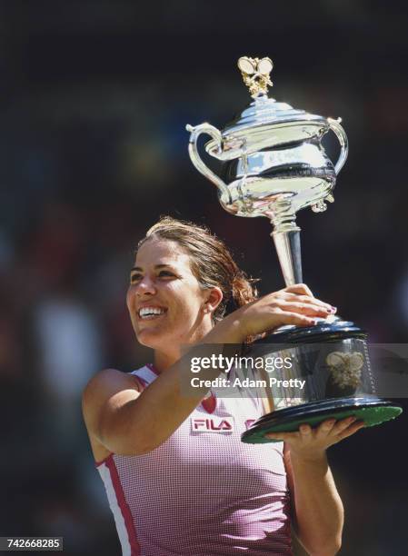 Jennifer Capriati of the United States lifts the trophy after winning the Women's Singles title against Martina Hingis at the Australian Open tennis...