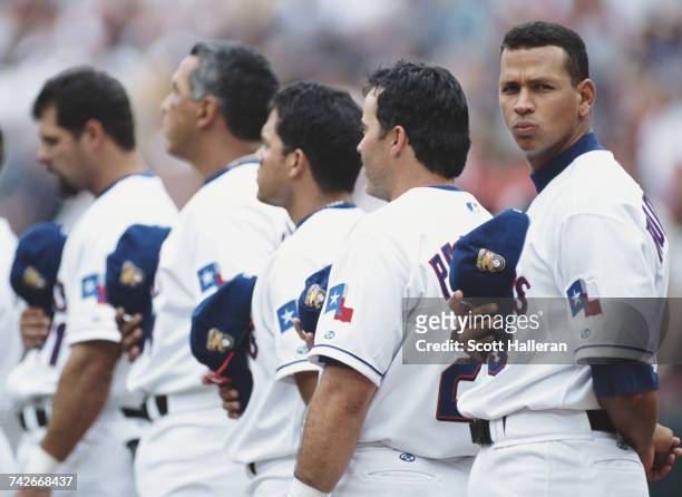 Alex Rodriguez of the Texas Rangers looks across as he stands in line with team mates Rafael Palmeiro, Ivan Rodriguez, Andras Galarraga and Ken...