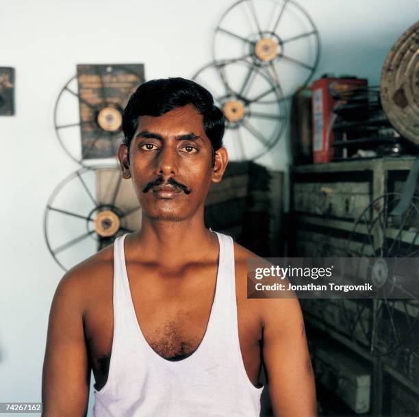 Projectionist at Shanti Cinema January 2000 in Chennai, India. Projectionists tend to work long hours and each typically shows a minimum of four each...