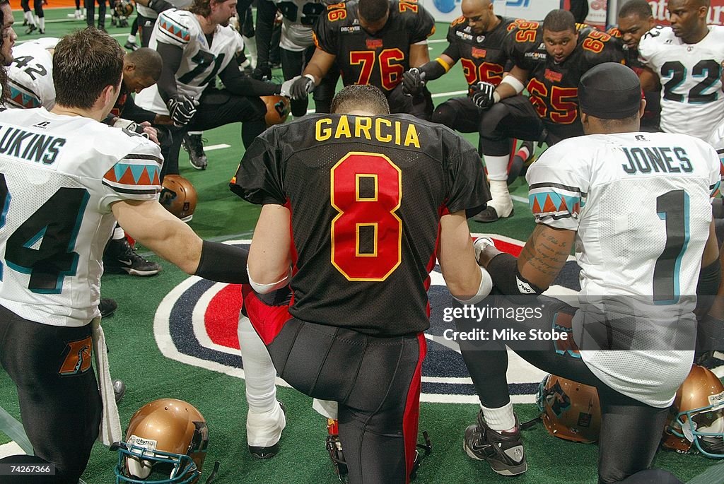 Aaron Rattler Ouarterback Aaron Garcia of the New York Dragons prays on the field ...