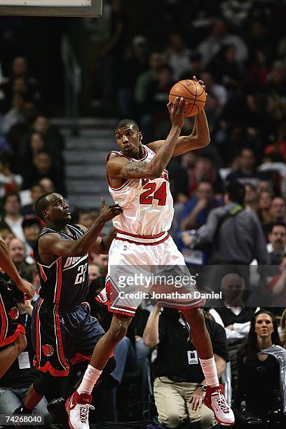 Tyrus Thomas of the Chicago Bulls controls a rebound past Brevin Knight of the Charlotte Bobcats on April 13, 2007 at the United Center in Chicago,...
