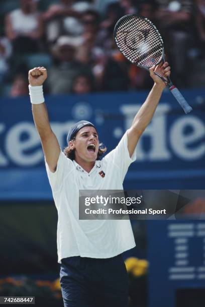 German tennis player Tommy Haas raises both arms in the air in celebration during progress to reach the semifinals of the Men's Singles tennis...