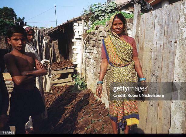 Woman of the Harijan caste stands amid dung patties October 28, 1991 in India. The Harijan caste is the lowest in the Hindu class hierarchy and its...