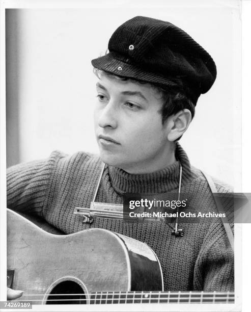 Bob Dylan wearing a motorcycle hat playing guitar in Columbia Recording Studio for a session in September 1961 in New York City, New York.