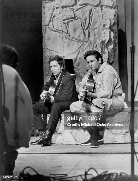 Bob Dylan and Johnny Cash perform together with acoustic guitars on 'The Johnny Cash Show' on June 7, 1969 in Nashville, Tennessee.
