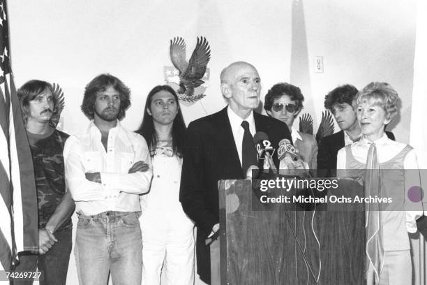 Joe Walsh, Don Felder, Timothy B. Schmit, Alan Cranston, Don Henley, Glenn Frey, and Norma Weintraub attend an event in 1980.