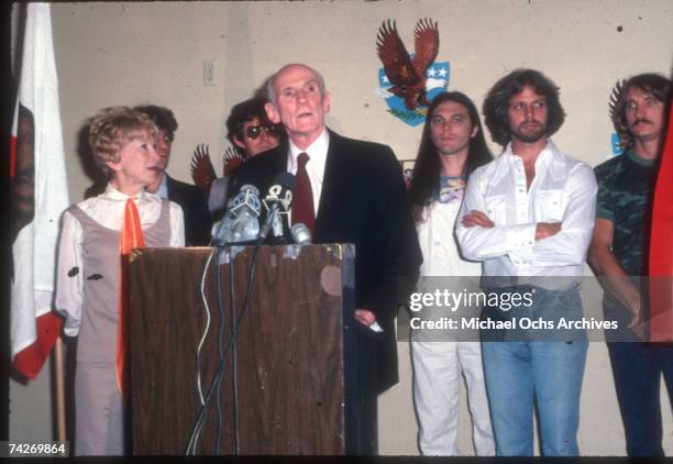 Joe Walsh, Don Felder, Timothy B. Schmit, Alan Cranston, Don Henley, Glenn Frey, and Norma Weintraub attend an event in 1980.
