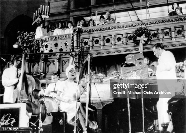 Composer Duke Ellington performs a 'concert of sacred music' with his orchestra as Lena Horne sings at the 5th Avenue Presbyterian Church on December...