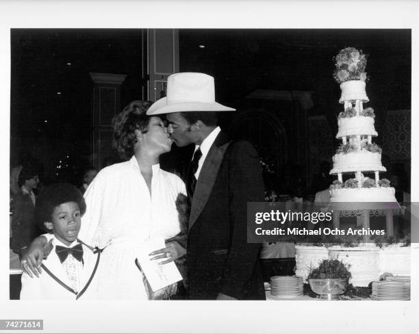 Soul singer Aretha Franklin kisses her new husband actor Glynn Turman as her son Kecalf Franklin looks on at their wedding at her father's New Bethel...