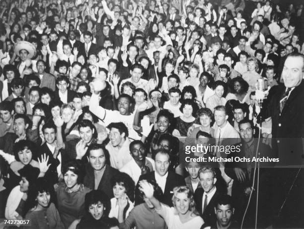 American disc jockey and promoter Alan Freed hosting a show for a multi-racial teenage audience, circa 1955.