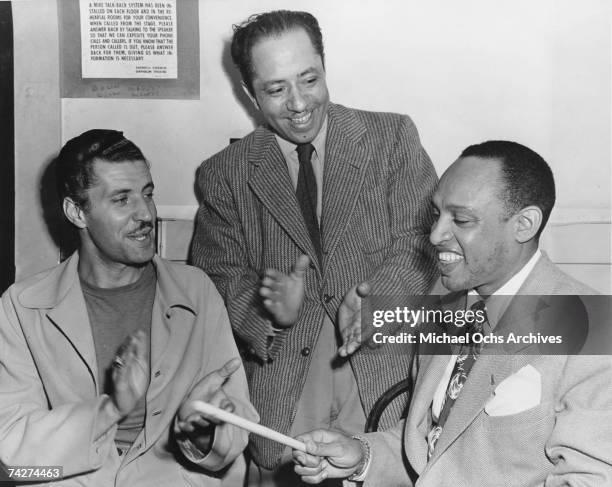 Crooner Herb Jeffries, songwriter Otis Rene and percussionist Lionel Hampton pose for a portrait in an office of Capitol Records on October 23, 1945...