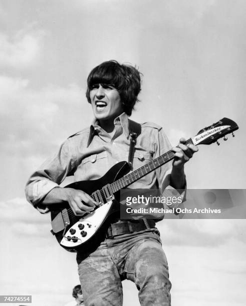 Guitarist George Harrison of the rock and roll band "The Beatles" performs onstage with a Rickenbacker electric guitar in circa 1966.