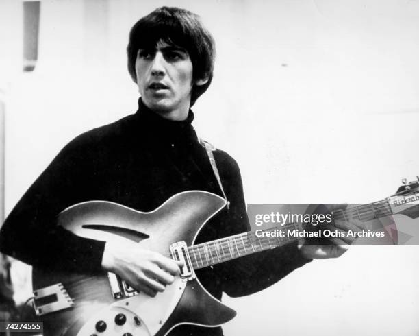 Guitarist George Harrison of the rock and roll band "The Beatles" records on a Rickenbacker electric guitar in the studio in circa 1965.