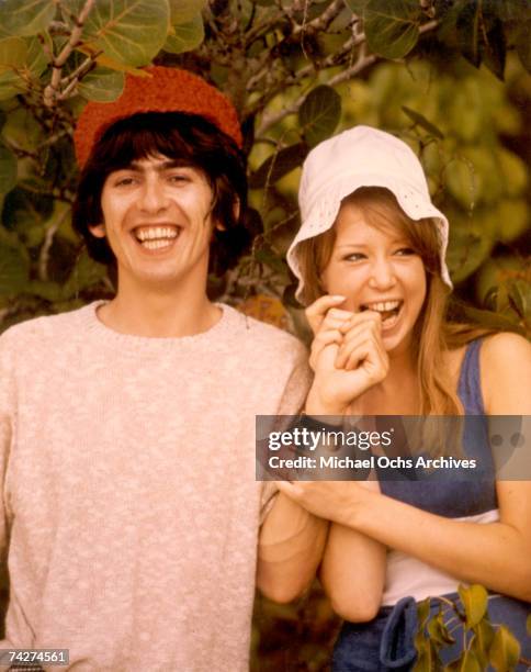 Guitarist George Harrison of the rock and roll band "The Beatles" poses for a portrait with his girlfriend Pattie Boyd in circa 1966.