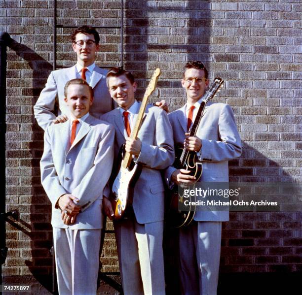 Buddy Holly poses for a portrait with his group Buddy Holly & The Crickets including Jerry Allison, Joe B. Mauldin, and Niki Sullivan holding a...