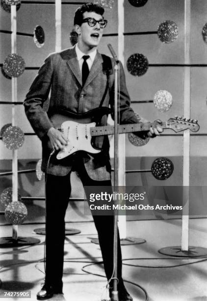 Buddy Holly of the rock and roll band Buddy Holly And The The Crickets plays a Fender Stratocaster guitar as he performs onstage on the set of the...