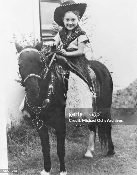 Buddy Holly in a cowboy outfit, riding a pony, circa 1945.