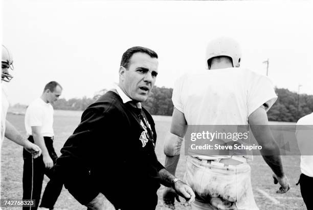 View of University of Notre Dame football coach Ara Parseghian as he conducts practice on the field, South Bend, Indiana, 1964.