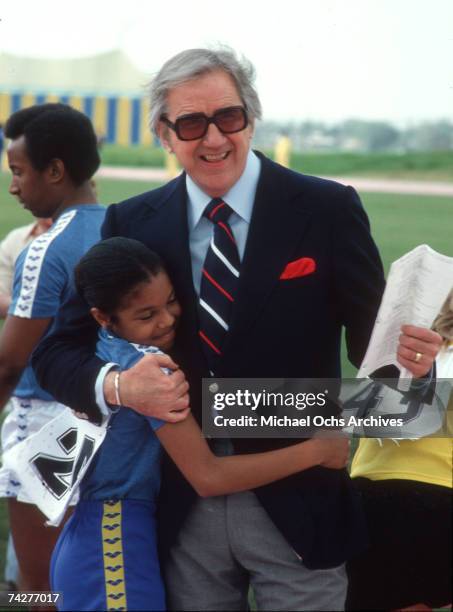 Pop singer Janet Jackson chats with talk show host sidekick Ed McMahon on set of the first episode of 'The Rock N' Roll Sports Classic' which aired...