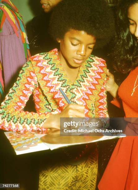 Pop singer Michael Jackson of the R&B quintet 'Jackson 5' performs onstage wearing a bright patterned shirt at a concert for the "Foundation for the...