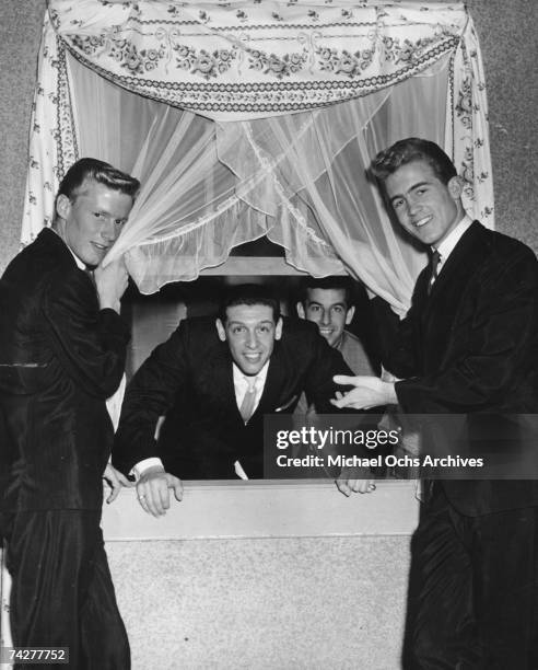 Surf rock duo Jan and Dean Dean Torrence, Gene Kaye , producer Lou Adler and Jan Berry pose for a portrait circa 1960.