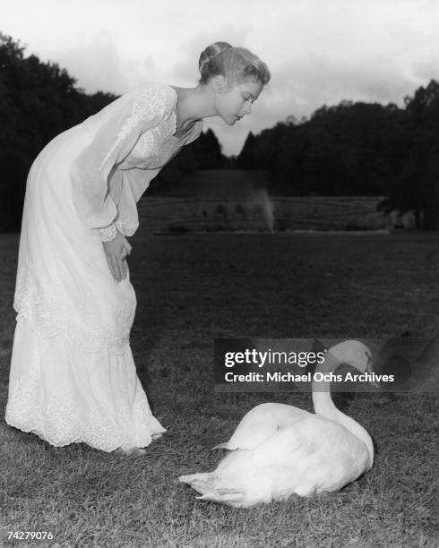 Grace Kelly poses with a swan on the set of the MGM movie titled "The Swan" on the set at the Biltmore Estate in 1956 in Asheville, North Carolina
