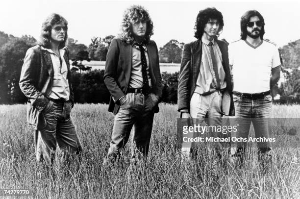 Rock band "Led Zeppelin" poses for a portrait in a field in 1977. John Paul Jones, Robert Plant, Jimmy Page, John Bonham.