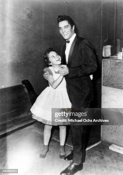 Rock and roll singer Elvis Presley with a very young Brenda Lee in 1956.