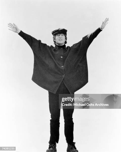 John Lennon of the rock and roll band "The Beatles" poses for a photo in the snow in March 1965 in Obertauern, Austria during a break from filming...