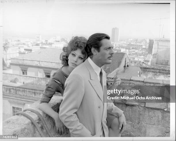 Actors Sophia Loren and Marcello Mastroianni pose for a publicity still on a rooftop during filming of the film "Marriage - Italian Style" in 1964.