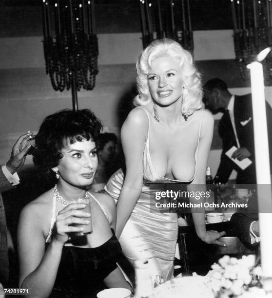 Jayne Mansfield tries to steal the show in a very low cut dress at a party thrown by 20th Century-Fox for Sophia Loren on April 12, 1957 in Los...