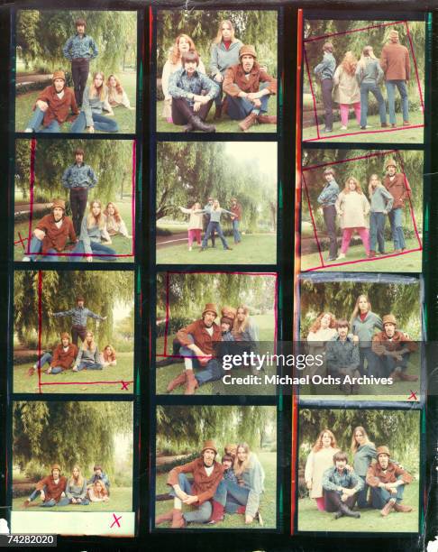 Mama Cass Elliott, John Phillips, Michelle Phillips, Denny Doherty of the folk group "The Mamas And The Papas" pose for a portrait session in a pool...