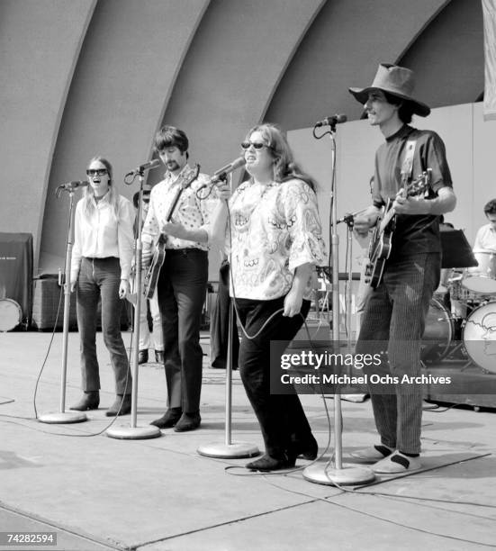 The folk group "The Mamas And The Papas" including John Phillips, Mama Cass, Michelle Phillips, and Denny Doherty pose for portraits and rehearse for...