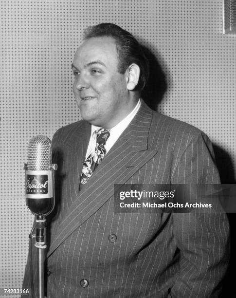 Composer Billy May records in Capitol Records studios on December 10, 1945 in Los Angeles, California.