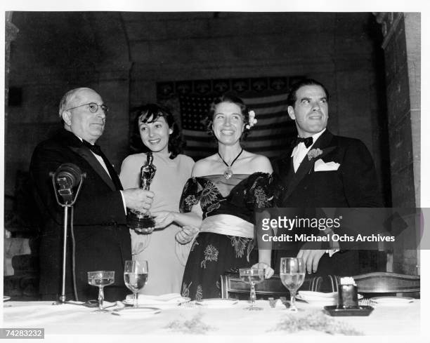 Boss Louie B. Mayer presents Louise Treadwell the Best Actor award for Spencer Tracy while Best Actress winner Luise Rainer and director Frank Capra...