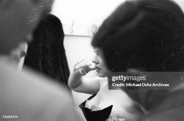 Movie star Marilyn Monroe gets fitted for her costume in a dressing room before riding a pink elephant in Madison Square Garden for a circus charity...