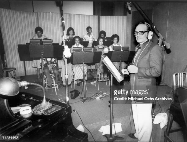Italian composer, arranger and conductor Ennio Morricone records a choral group for the score of the Warner Bros film 'Exorcist II: The Heretic' in...