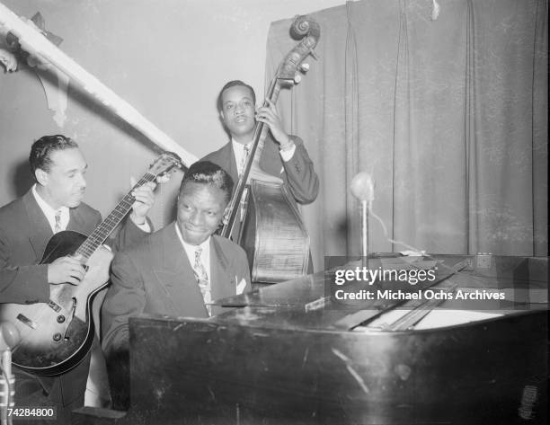 Guitarist Oscar Moore, pianist Nat 'King' Cole and bassist Johnny Miller of the "Nat 'King' Cole Trio" record in Capitol Records studios on December...