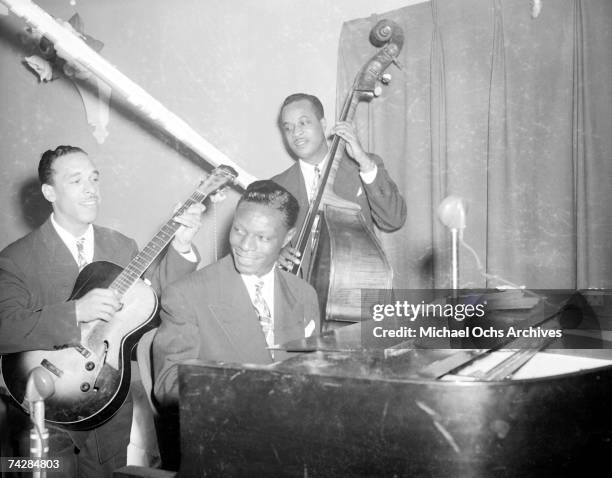 Guitarist Oscar Moore, pianist Nat 'King' Cole and bassist Johnny Miller of the "Nat 'King' Cole Trio" record in Capitol Records studios on December...