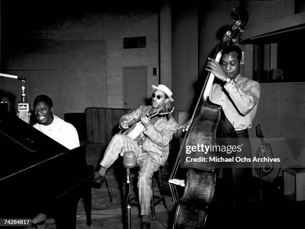 Pianist Nat 'King' Cole, guitarist Oscar Moore and bassist Johnny Miller of the "Nat 'King' Cole Trio" record in Capitol Records studios on March 15,...