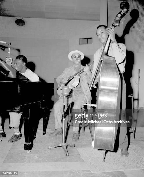 Pianist Nat 'King' Cole, guitarist Oscar Moore and bassist Johnny Miller of the "Nat 'King' Cole Trio" record in Capitol Records studios on March 15,...