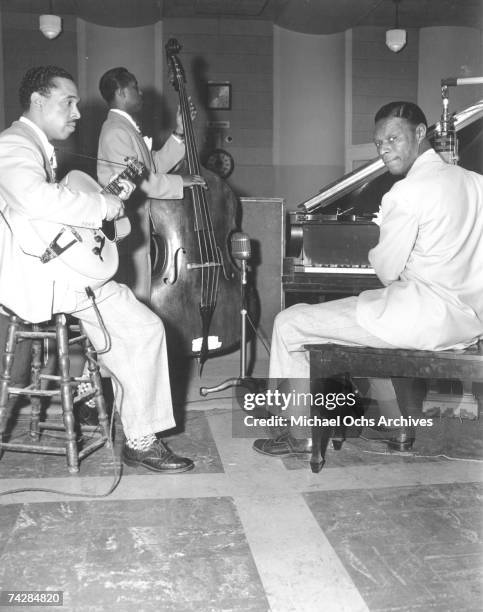 Pianist Nat 'King' Cole, guitarist Oscar Moore and bassist Johnny Miller of the "Nat 'King' Cole Trio" record in Capitol Records studios on March 15,...